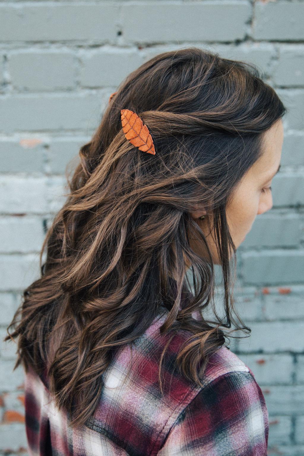A leather leaf clipped into long brown hair